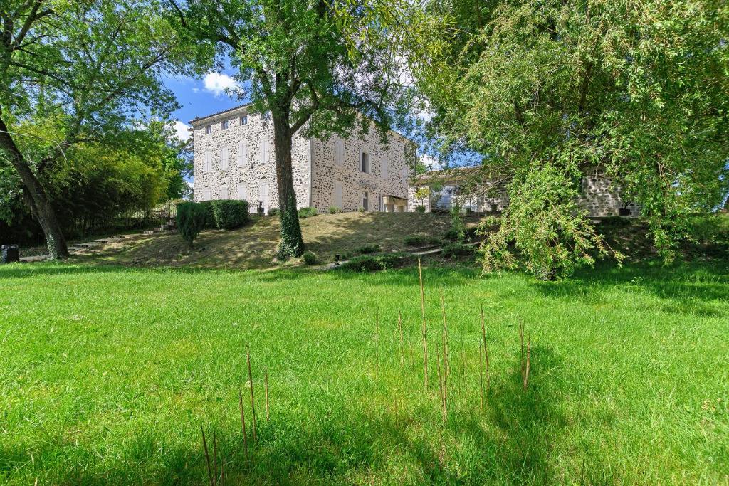 a large building in a field with trees and grass at Domaine du chemin Royale in Saint-Germain