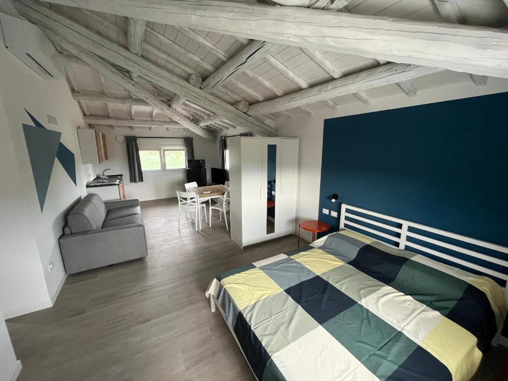 a bedroom with a bed and a blue wall at Le Nogare in Abano Terme