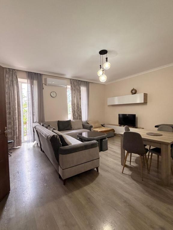 a living room with a couch and a table at Amazing flat in the best location in Tsqaltubo