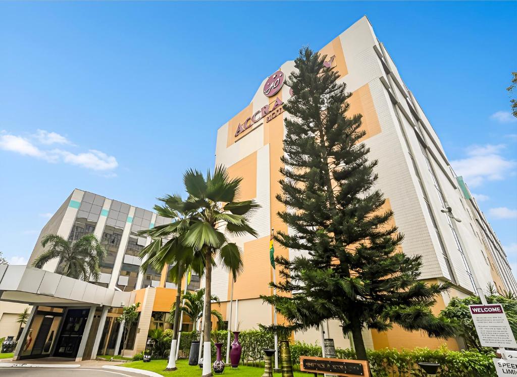 a christmas tree in front of a building at Accra City Hotel in Accra