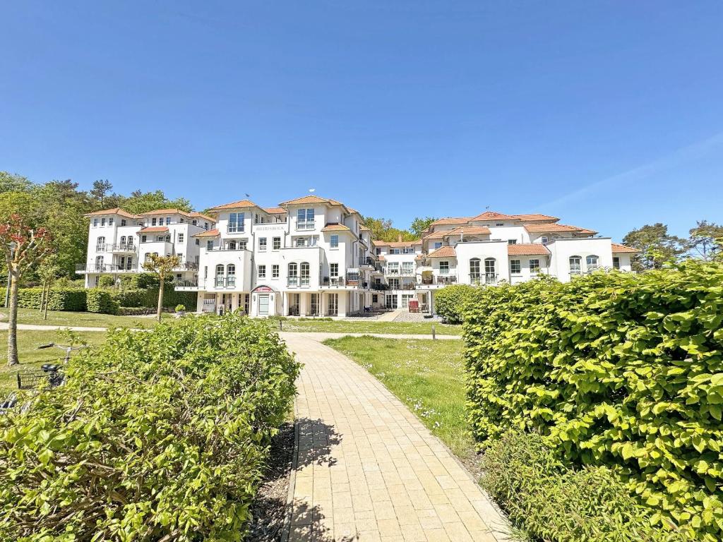 a row of houses with a pathway in front of them at Haus Meeresblick A 2 12 BLU in Baabe