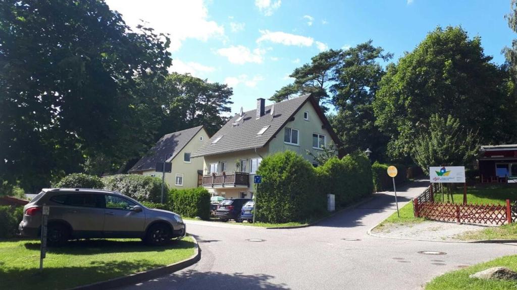 a car parked in the driveway of a house at Brandt Ferienwohnungen Jägersberg in Ahlbeck