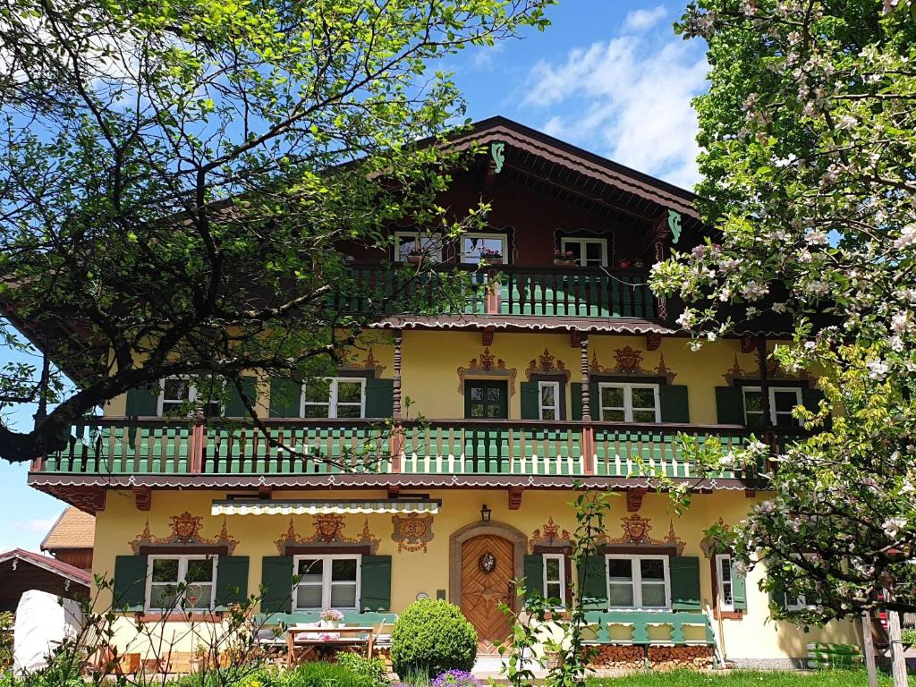 a large house with a balcony on top of it at Landhaus SeenSucht in Schliersee