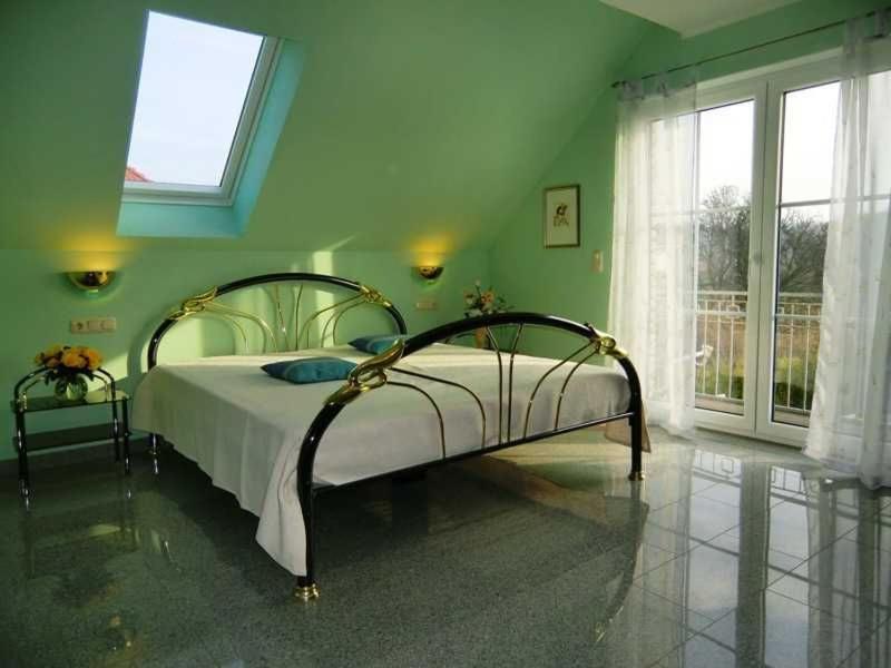 a bedroom with a bed in a green room at Appartements Villa Drachenberg in Sassnitz