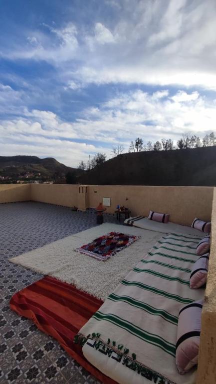 a large bed sitting on top of a roof at Jnan Narjiss atlas in Asni