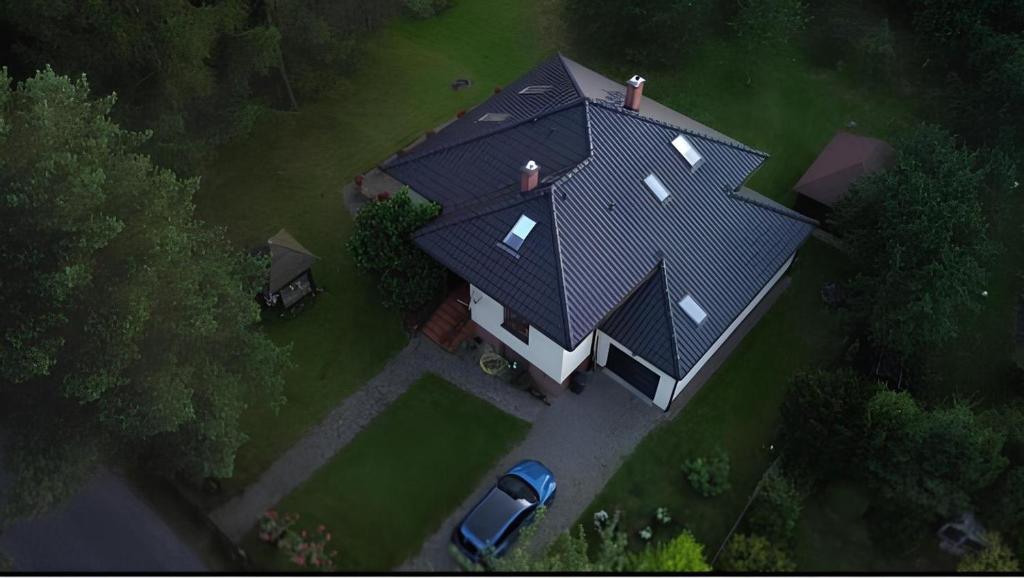 an overhead view of a large house with a black roof at Domek Gierczyn 16 in Gierczyn