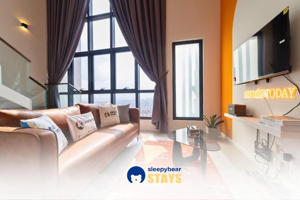 a living room with a couch and a tv at HighPark Suites Kelana Jaya, Petaling Jaya by Sleepy Bear in Petaling Jaya