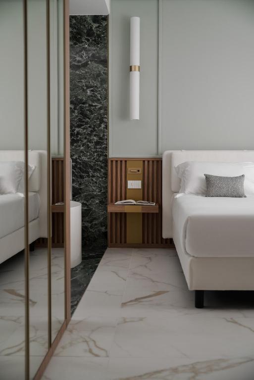 a living room with a couch and a table at Parioli Hotel Rimini in Rimini