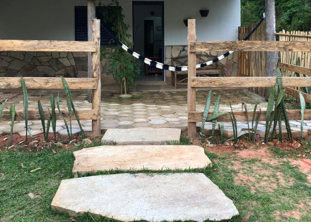a group of stepping stones with a fence and a gate at Quinta da Ana, Casa de Roça in Baependi