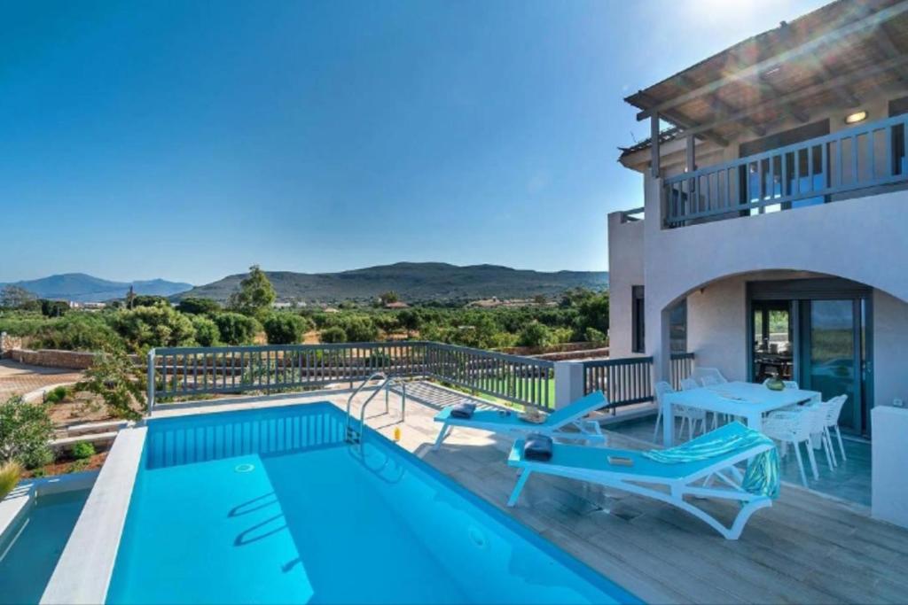 a villa with a swimming pool and a patio at Elafonisos Aqua Villa I in Elafonisos
