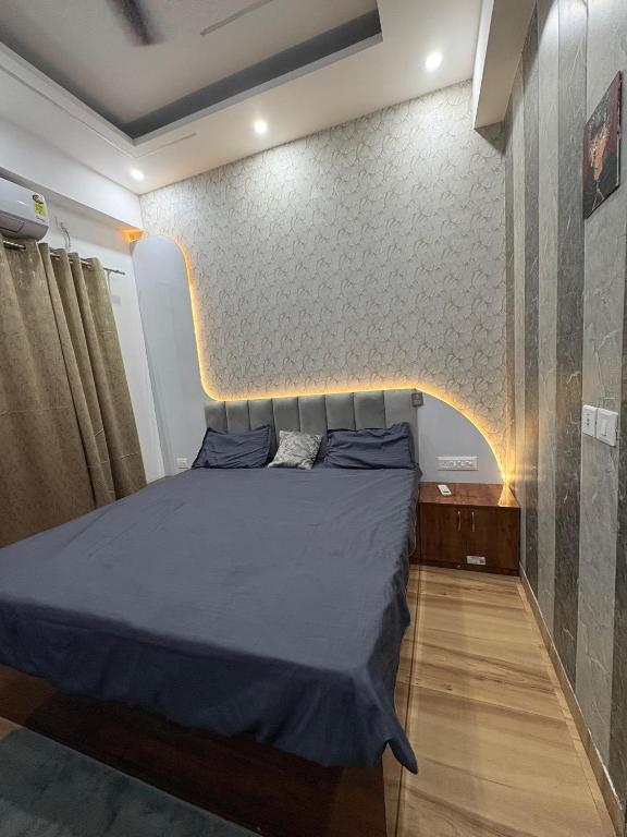 a bedroom with a bed and a wall at THE COZY STAY STUDio in Greater Noida