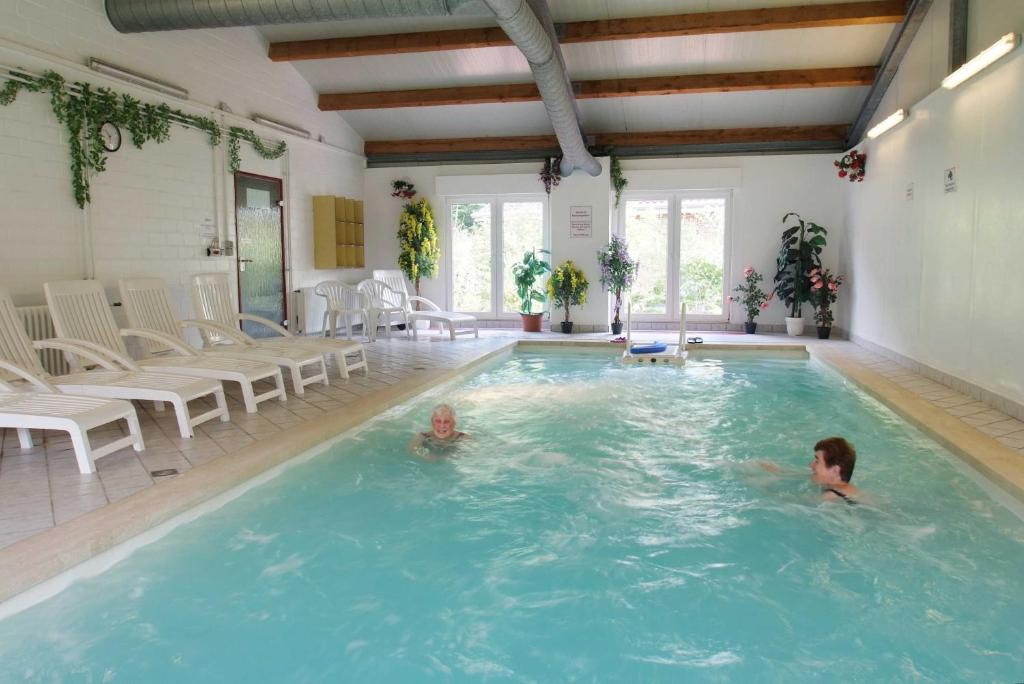 two children swimming in a swimming pool at Ferienzentrum Brouwer, 75010 in Westoverledingen