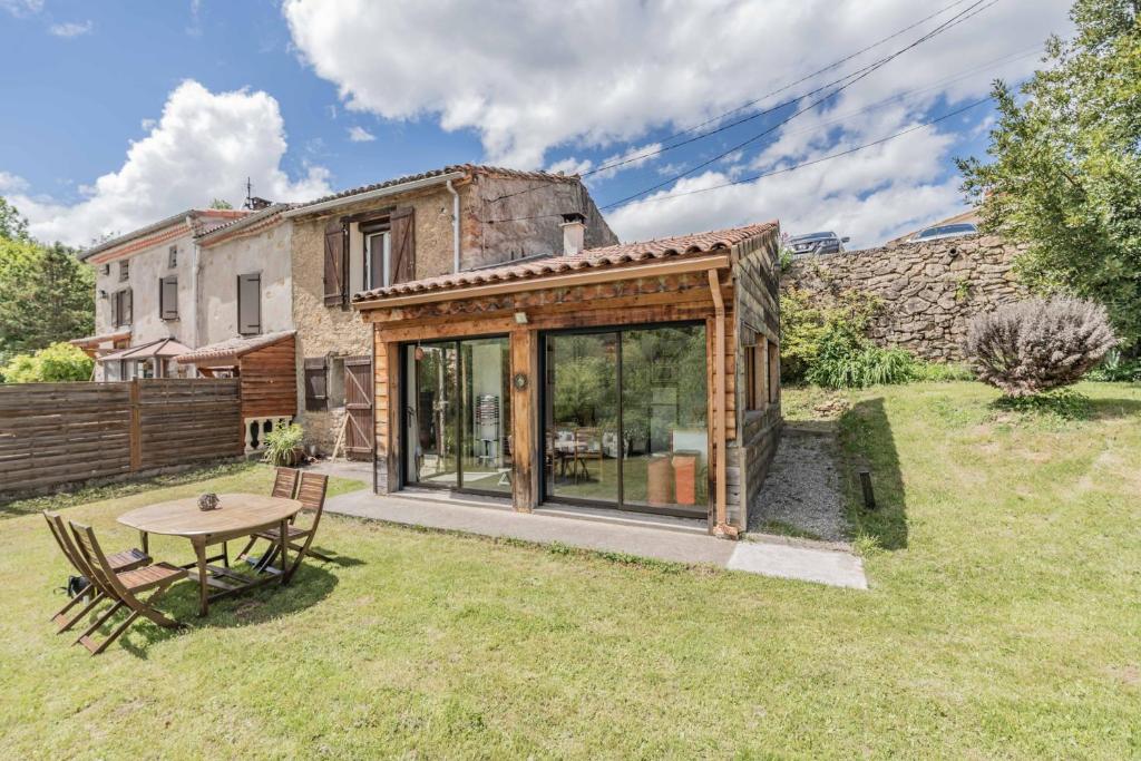 an external view of a house with a table in the yard at La Barraço in Nalzen