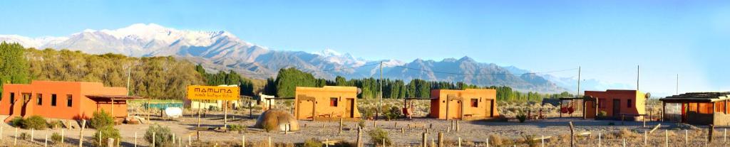 a group of buildings in front of a mountain at Mamuna Casas Loft in Uspallata