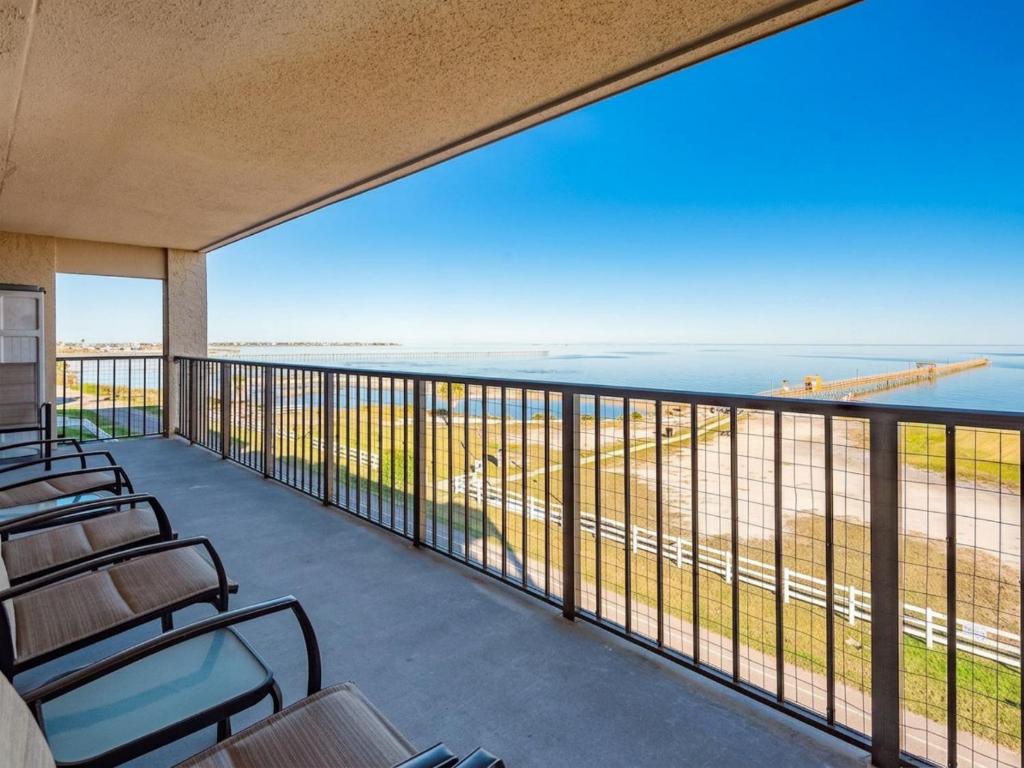 a balcony with chairs and a view of the ocean at Laguna Reef #413 - Waters Edge in Rockport