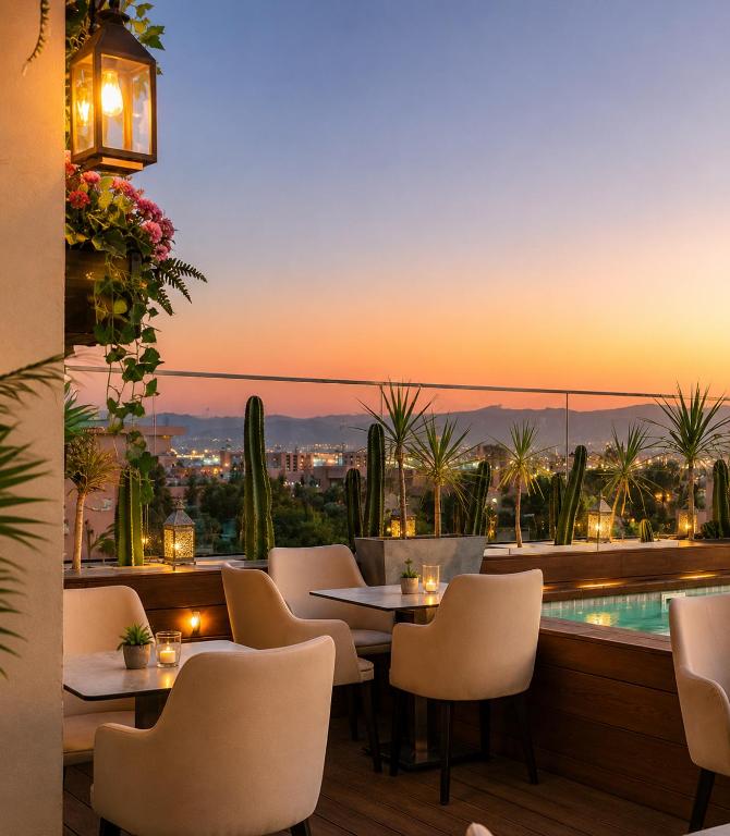 a restaurant with a view of the city at sunset at Appart-hotel Marrakech Inn in Marrakesh