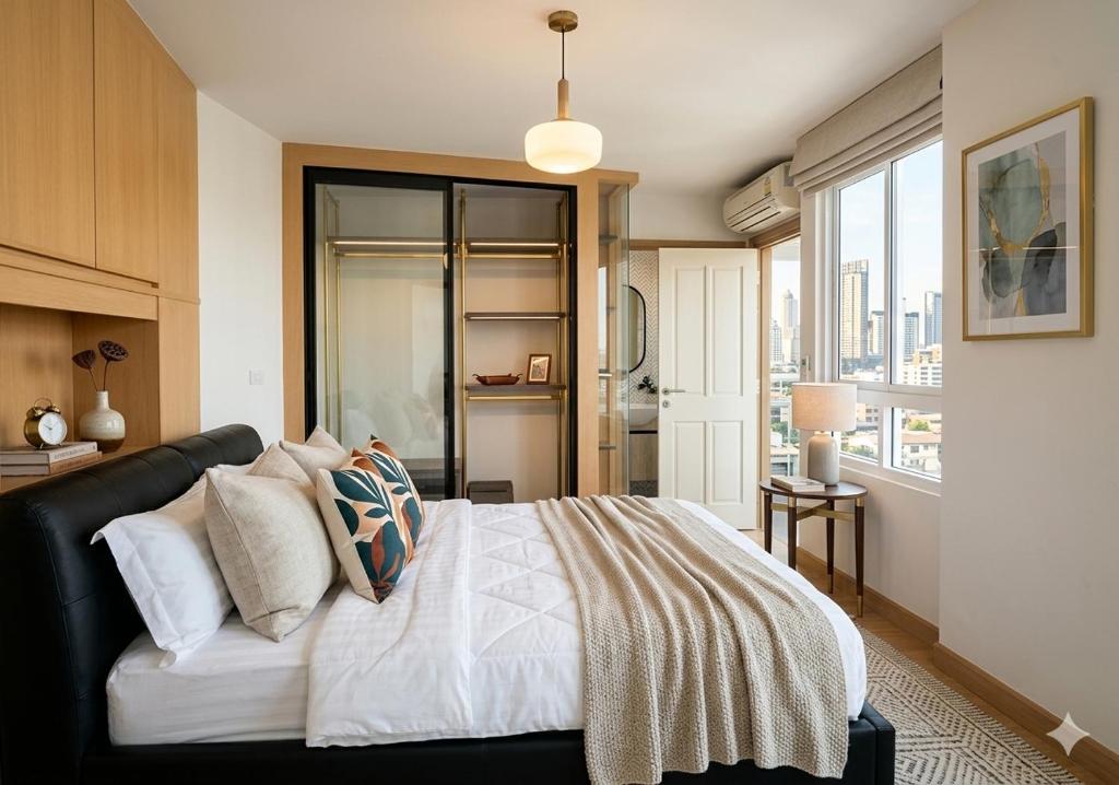 a bedroom with a bed and a large window at Cozy Minimal 1BR CMBD Pool Long Stay Friendly in Phra Khanong