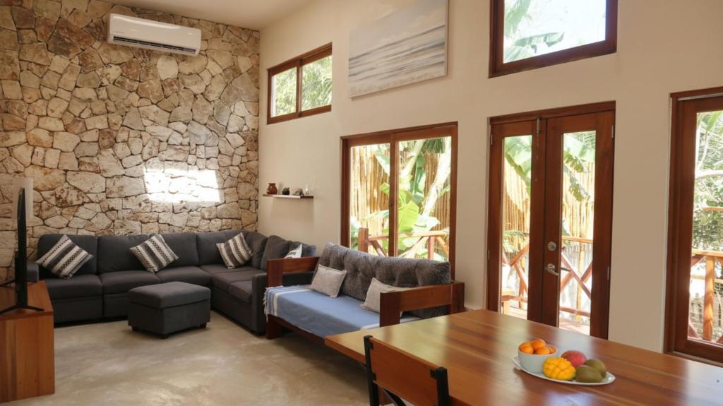 a living room with a couch and a table at Casa Mayali - Walk to Lagoon in Bacalar