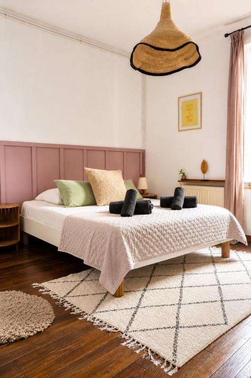 a bedroom with a large bed with two pillows at L'Escapade Mussipontaine in Pont-à-Mousson