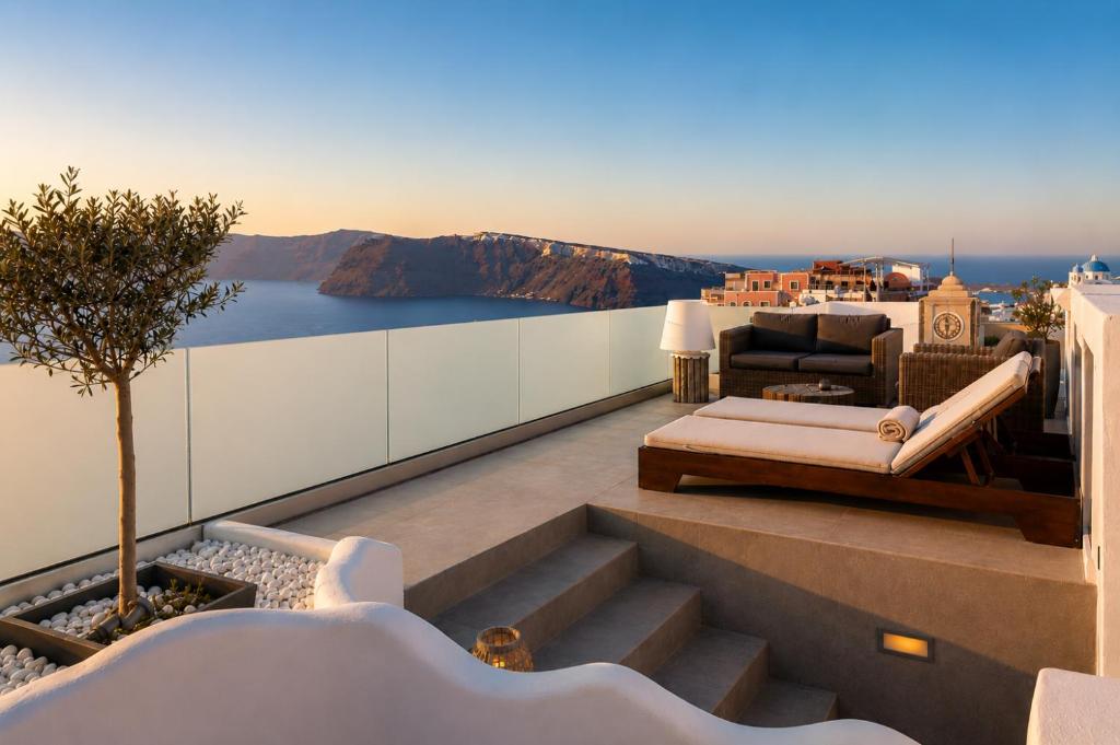 a balcony with a view of the ocean at The Museum Project Oia in Oia