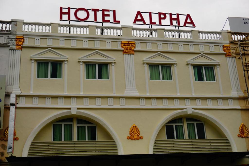a building with a hotel alpha sign on top of it at Hotel Alpha in Bukit Mertajam