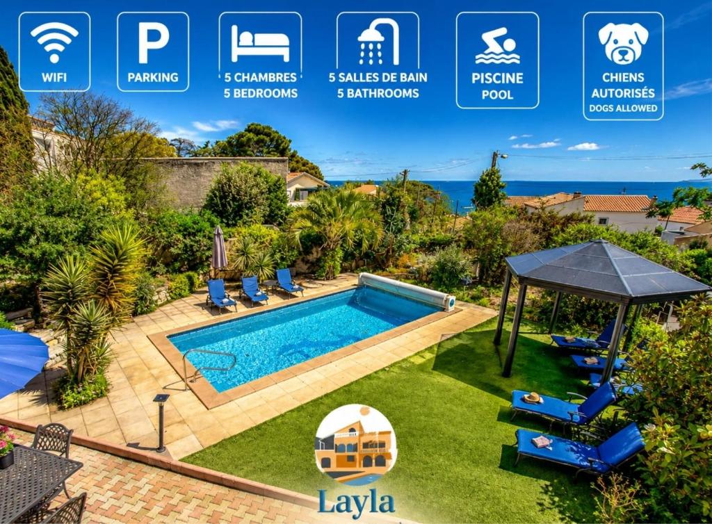 a swimming pool in a yard with a villa at Villa Layla - 5 étoiles - 10 personnes - Vue mer in Sète