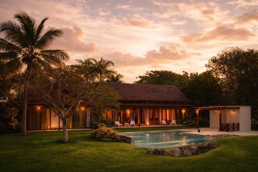 a villa with a swimming pool in front of a house at Villa Alda Bávaro in Punta Cana
