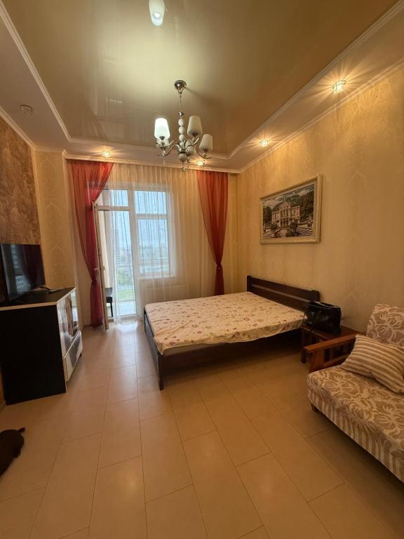 a large room with a bed and a couch at Квартира Марсельська in Kryzhanivka