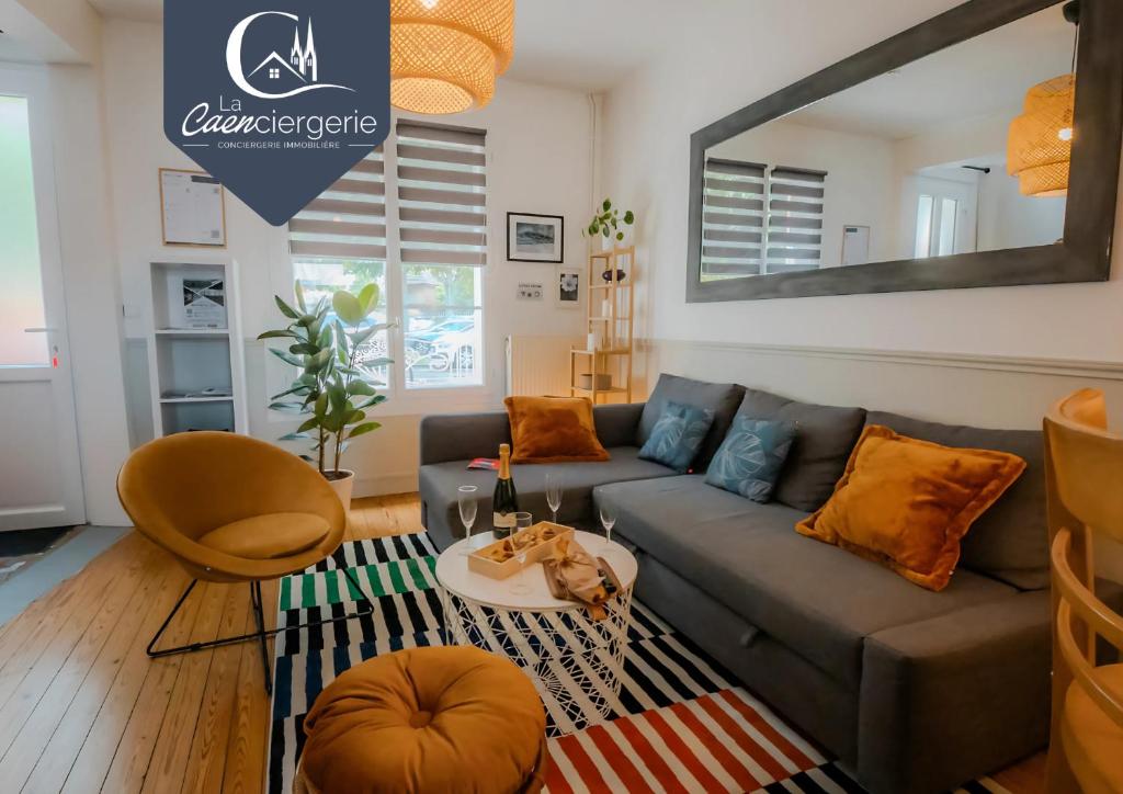 a living room with a couch and a table at La Maison du Parc - 2 chambres proche polyclinique in Caen