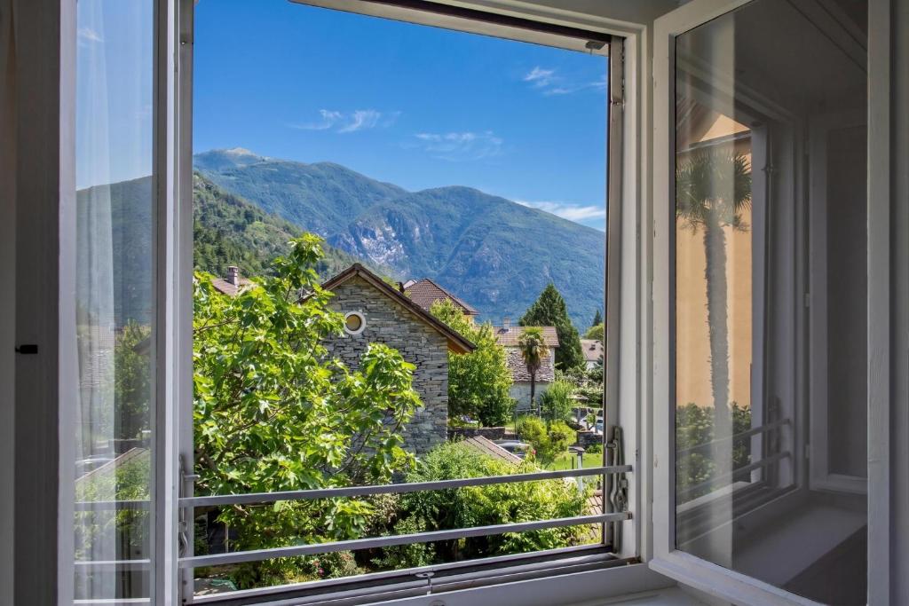 a window with a view of a mountain at Residenza La Serenata in Cavigliano