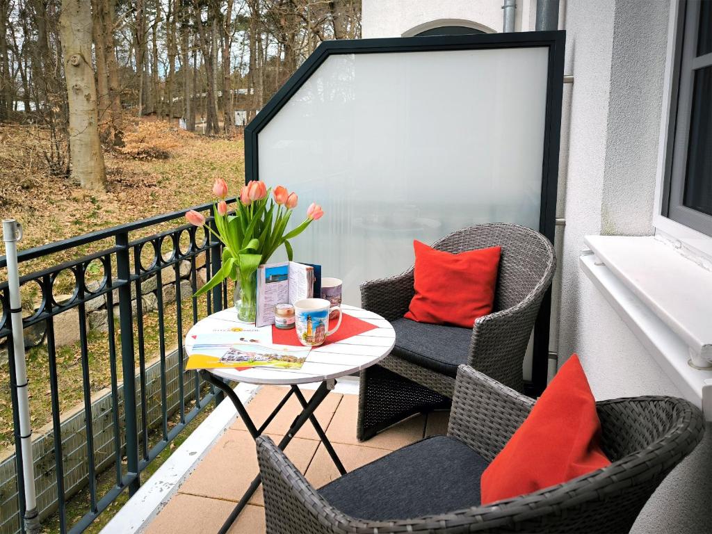 a patio with two chairs and a table on a balcony at Haus Meeresblick - Ferienwohnung Kreideküste (Ref. 151261) in Baabe