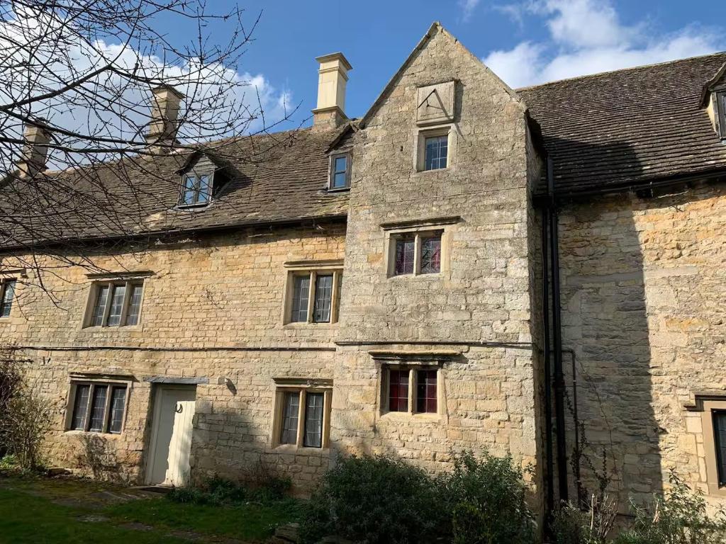 an old stone building with a roof at 6 Bedroom Farm House with 12 Beds in Weldon in Weldon