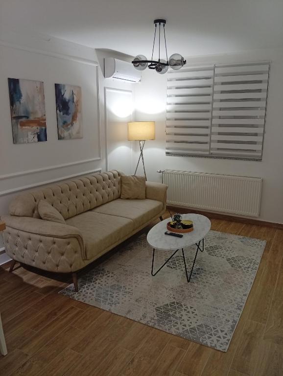 a living room with a couch and a table at Mozart apartman in Bijeljina