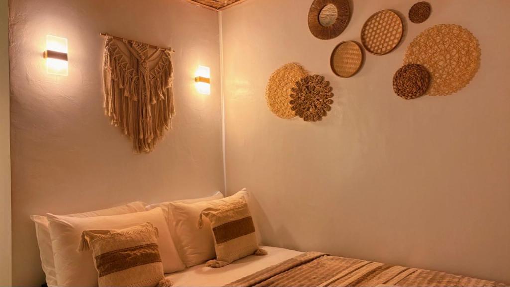 a bedroom with a bed with hats on the wall at Solenta trace 01 in El Nido