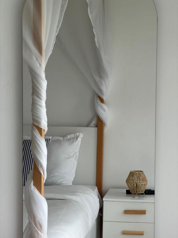 a bedroom with a bunk bed with white sheets at Perle Bleue de Gammarth in Gammarth