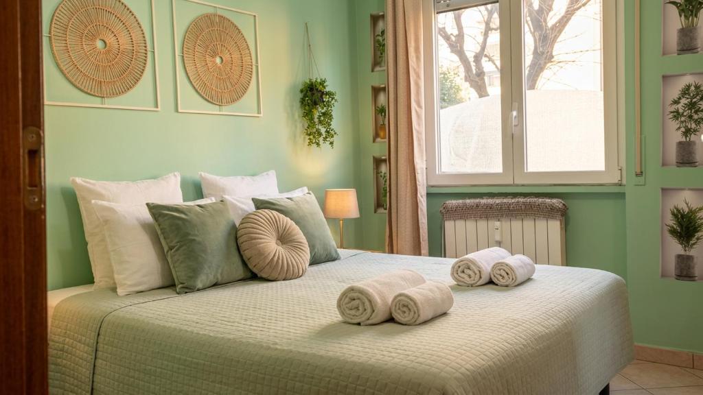 a bedroom with a bed with rolled towels on it at Casa Giulia Affittacamere FORUM ASSAGO M2 M1 Milano CENTRO in Corsico