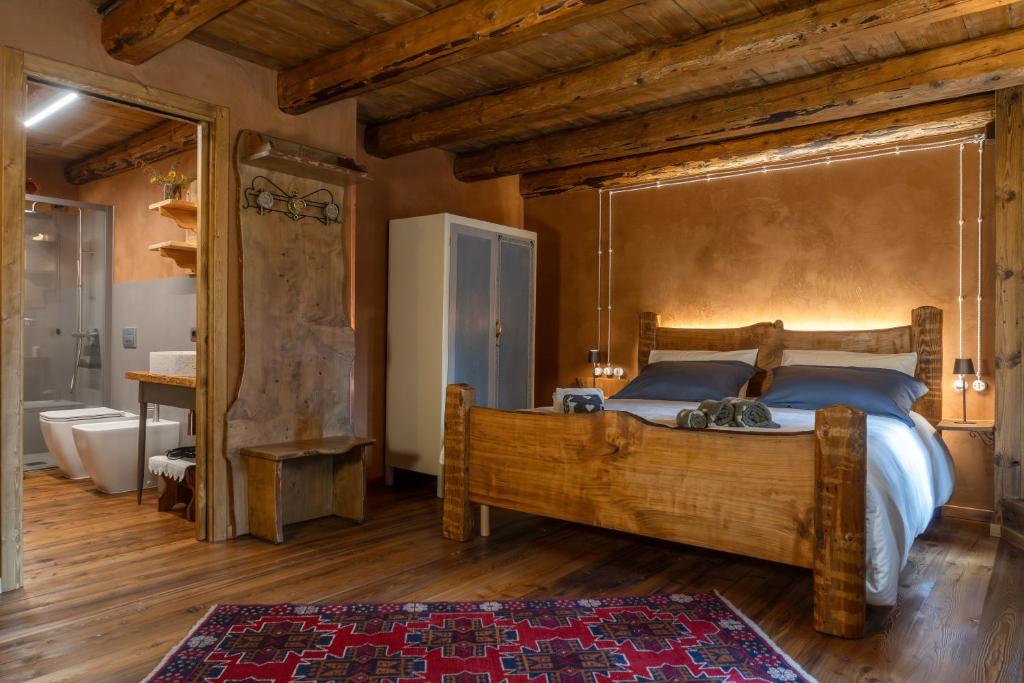 a bedroom with a large bed and a tub and a sink at Ristoro la Crosetta in Caneva