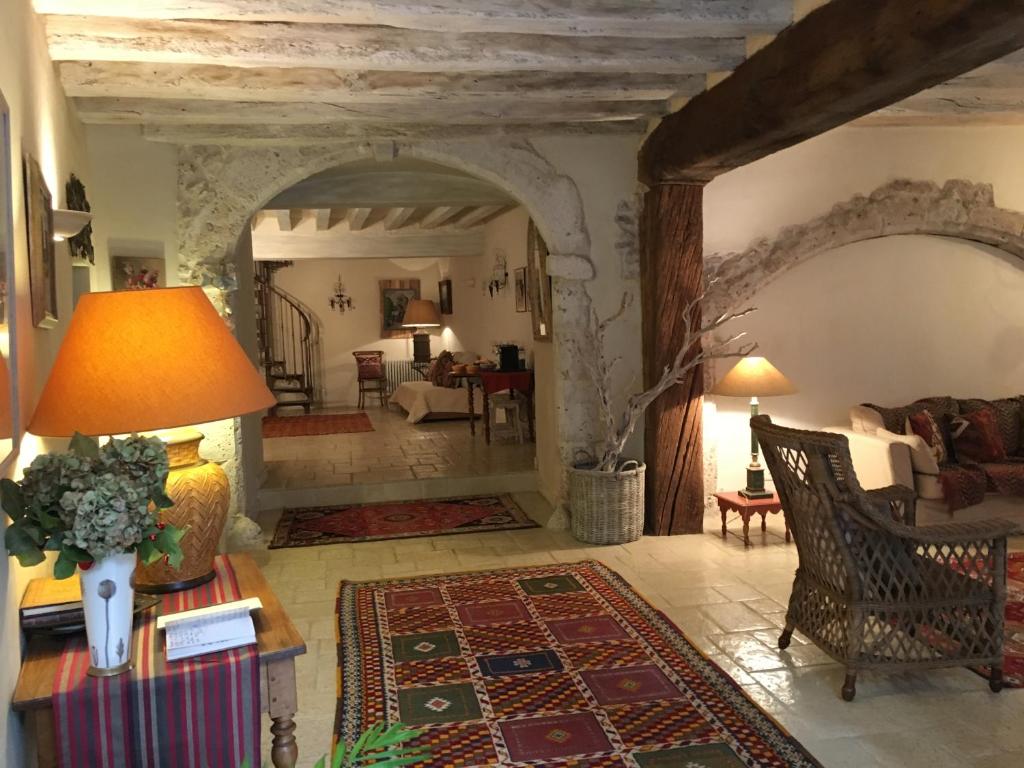 a living room with a couch and a table at Maison d'Ines centre historique garage privé in Blois