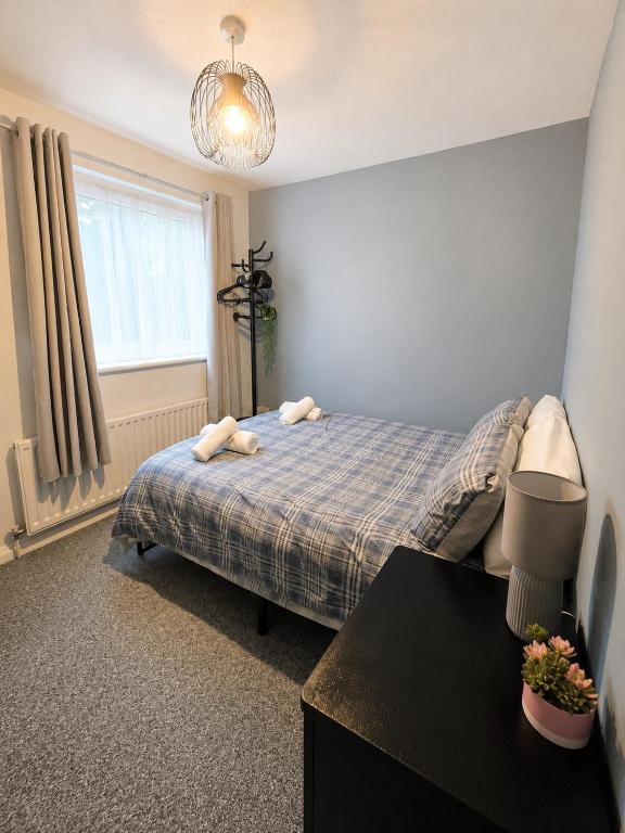 a bedroom with a bed with two towels on it at Cosy Double Room Near Cardiff Bay Waterfront in Cardiff