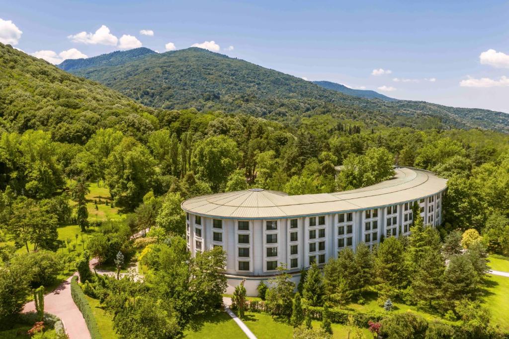 an aerial view of a building with mountains in the background at NG Sapanca Wellness & Convention in Sapanca