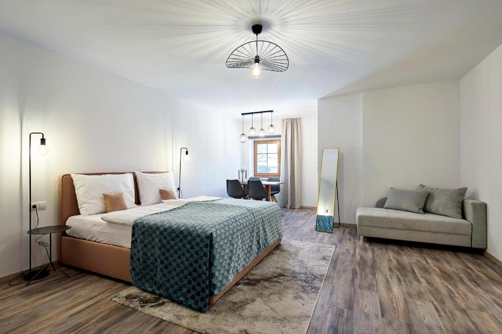 a bedroom with a large bed and a couch at Ladurnhof in Silandro