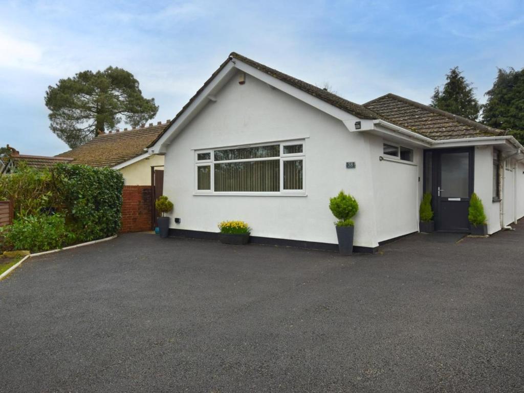 a white house with a driveway at 2 Bed in Ferndown oc-78541 in Ferndown