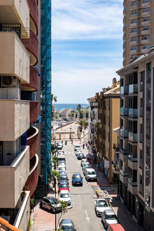 a view of a city street with cars parked at Terraza y Parking - Ático Capitán - Koti Rentals in Fuengirola