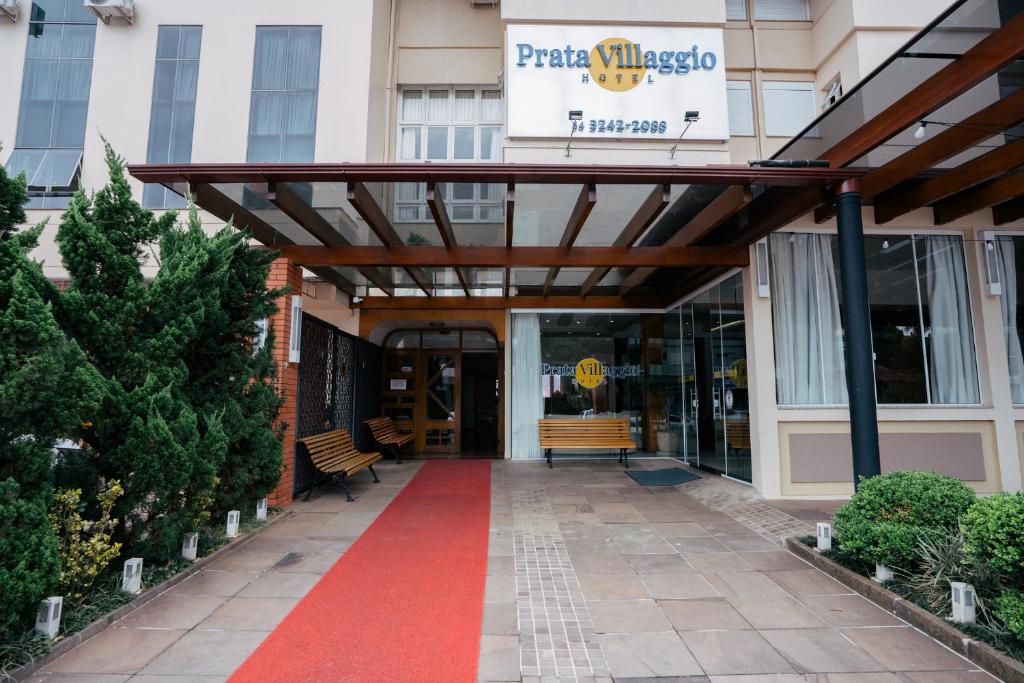 awning over the entrance to a building with a red carpet at Hotel Prata Villaggio in Nova Prata