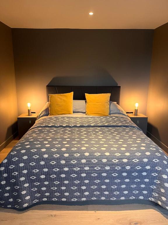 a bedroom with a large bed with two yellow pillows at Cool Getaway in Appin in Portnacroish