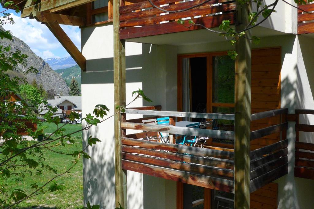 a balcony of a house with a table and chairs at A27 Chalet du Galibier in Valloire
