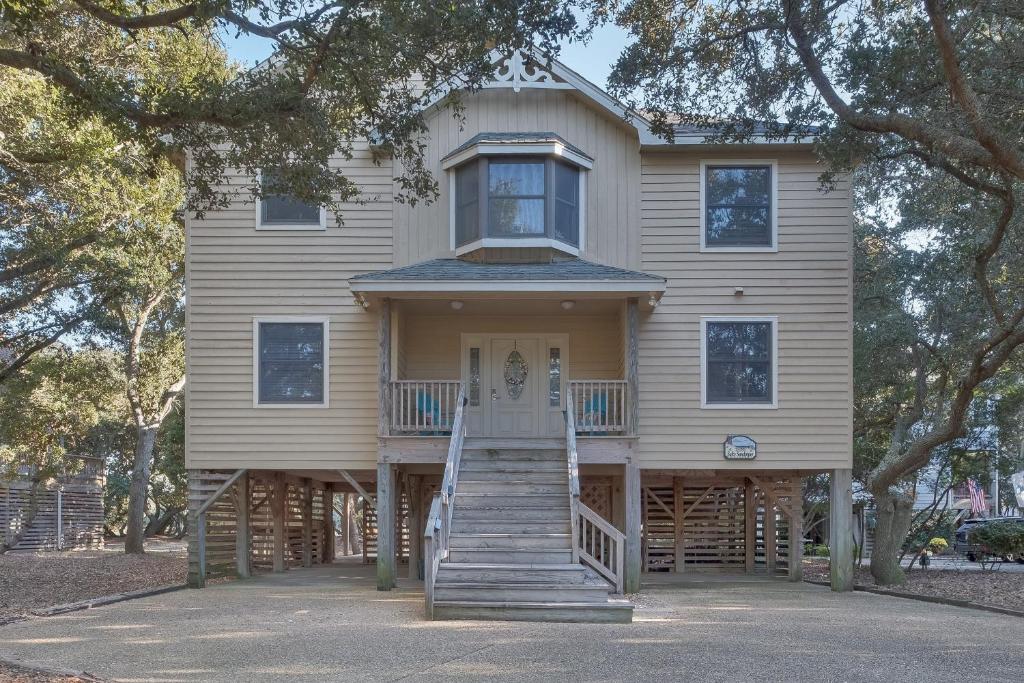 a large house with stairs leading to the front door at 2507 - Salty Sandpiper in Duck