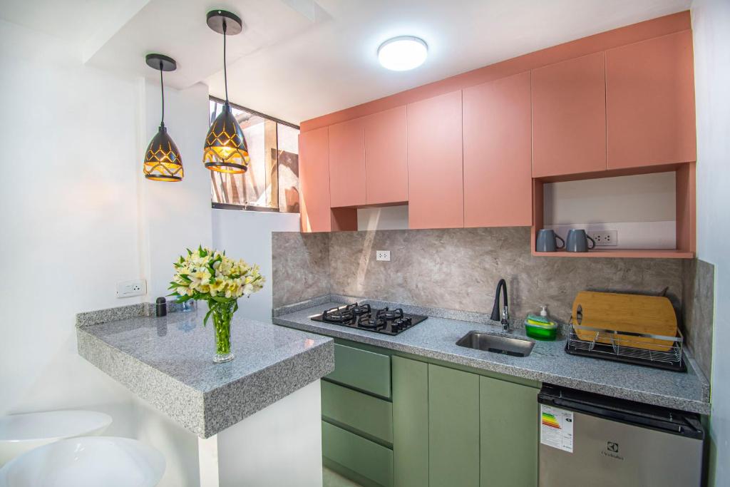 a kitchen with colorful cabinets and a counter top at Alpacasa Arequipa in Arequipa