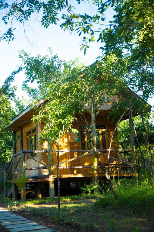 a log cabin in the woods with a porch at Tctc & Camp in Shikurufumi