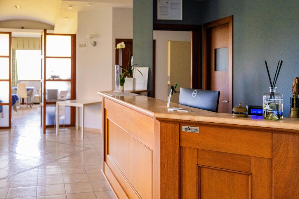 a kitchen with a counter with a laptop on it at Hotel La Fonte in Osimo